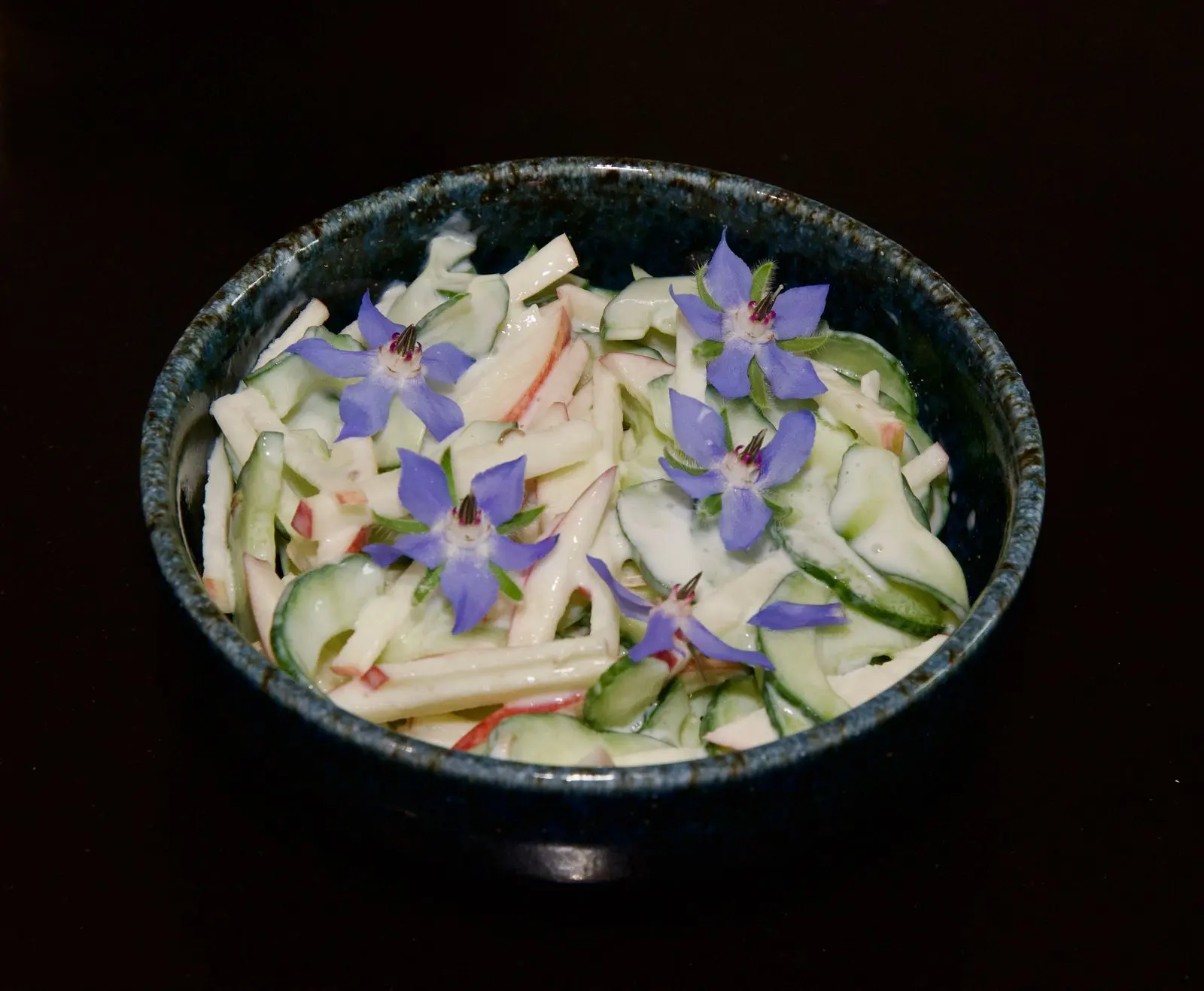 Cucumber, apple, and fennel seed salad, with borage for colour.
