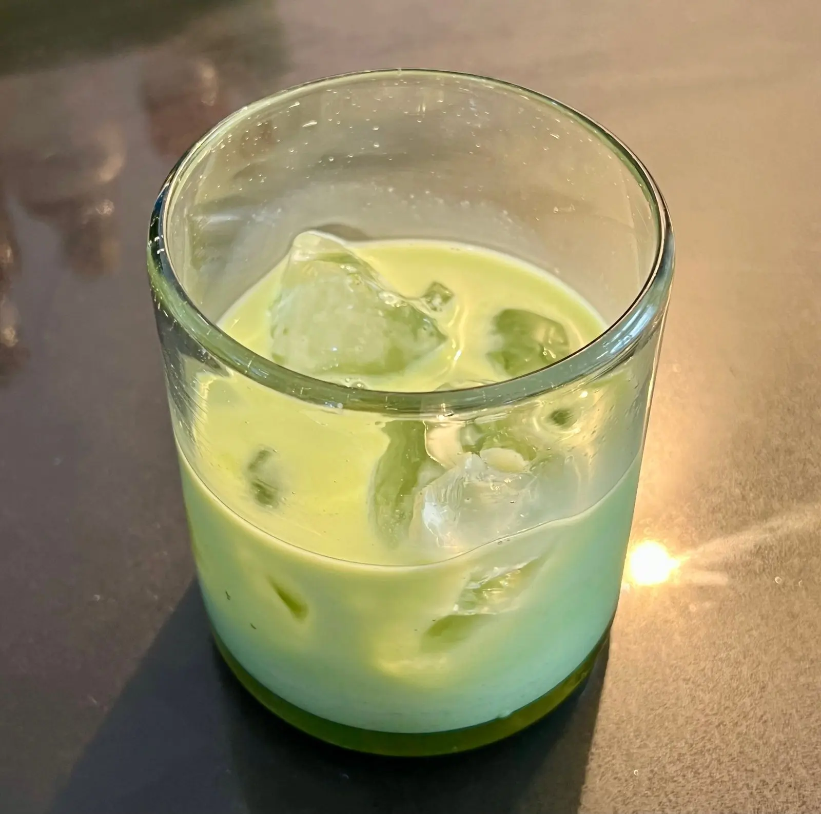 A glass of an oat latte menta made with water mint syrup
