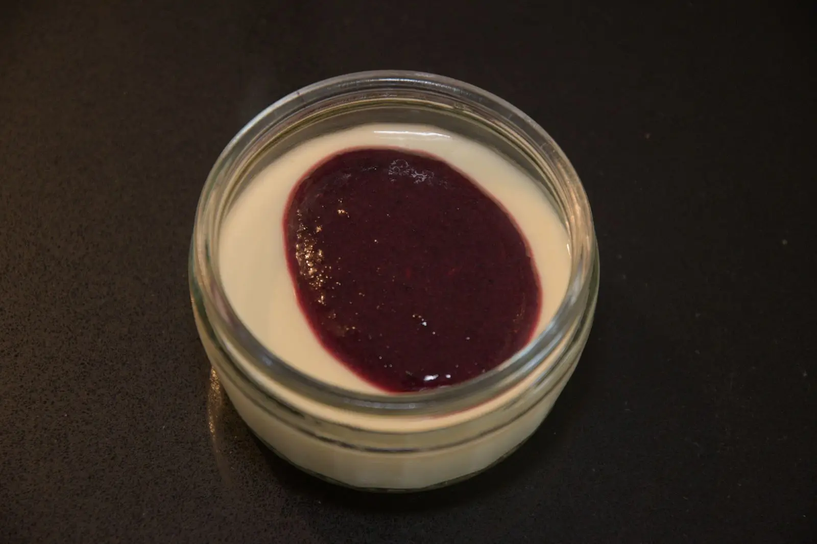 Lemon posset topped with lacto-fermented blueberry and pine sauce.